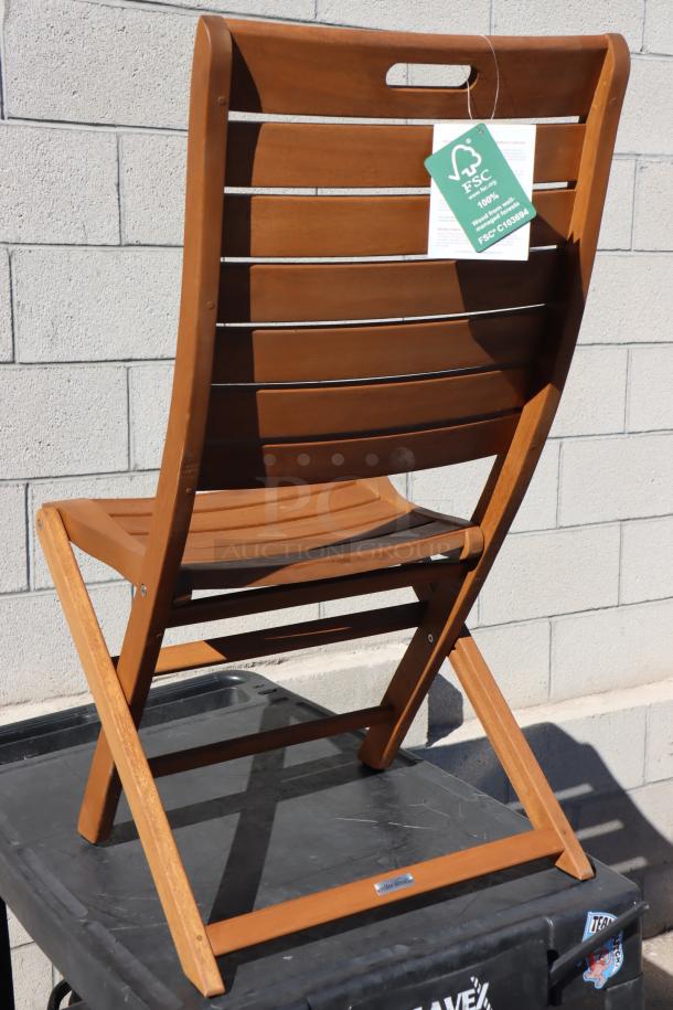 Brand new Outdoor Interiors Model 10050 Eucalyptus folding chair, scratch-n-dent condition, FSC-certified tag visible.