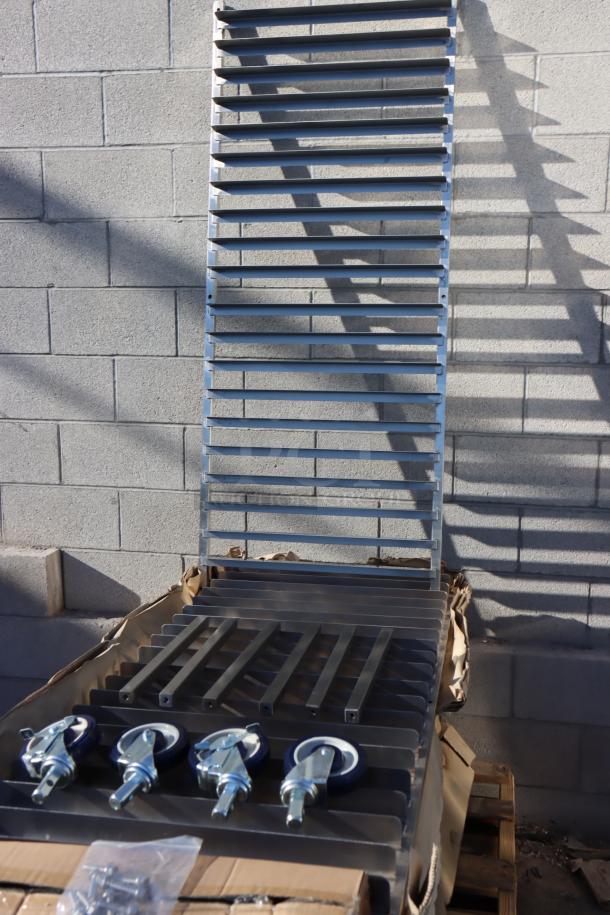 BRAND NEW Regency 600PR20316K 20 Pan Stainless Steel Rack, unassembled, rain-damaged packaging, includes wheels.