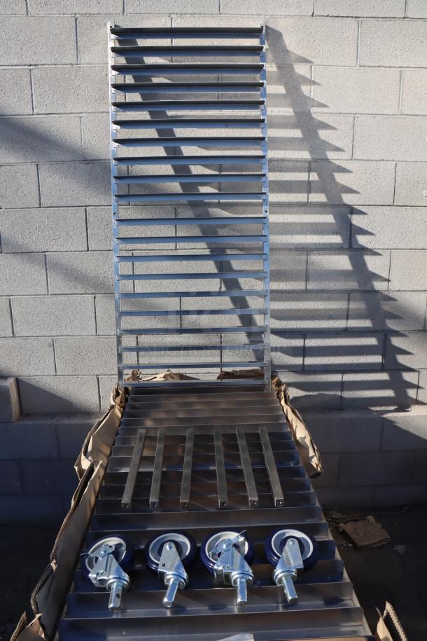 BRAND NEW Regency 600PR20316K, 20 pan stainless steel bun rack, unassembled, rain-damaged packaging, visible casters.