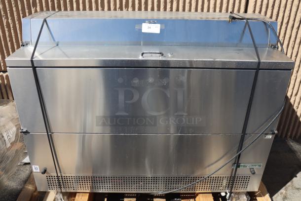 Brand new True TMC-58-S-DS-SS-HC milk cooler, 58 1/4", stainless steel, dented bottom, light scratches near handles.