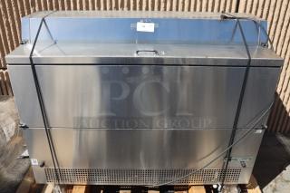 Brand new True TMC-58-S-DS-SS-HC milk cooler, 58 1/4", stainless steel, dented bottom, light scratches near handles.