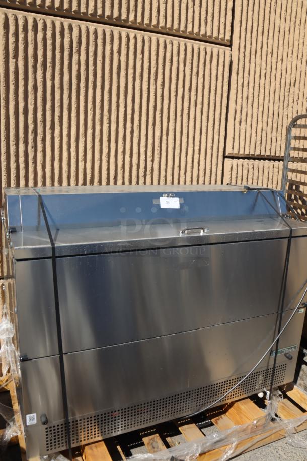 Brand new True TMC-58-S-DS-SS-HC milk cooler, stainless steel, 58 1/4", dented bottom, light scratches near handles.