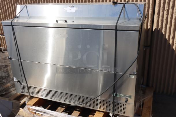 Brand new True TMC-58-S-DS-SS-HC milk cooler, 58 1/4", with stainless steel interior/exterior. Bottom dented, light scratches near handles.