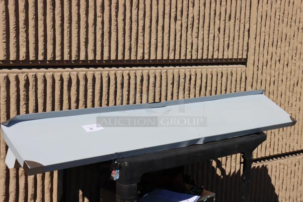 Brand new Regency 600PS1272 12"x72" stainless steel pot rack with shelf, scratch-n-dent condition, visible label with lot number.