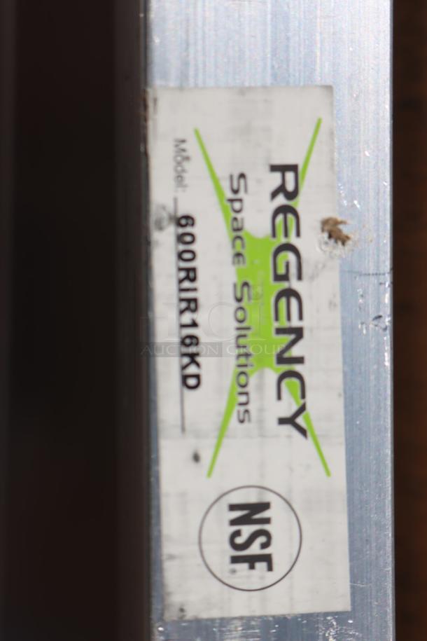 Regency 600RIR16KD label on aluminum pan rack; NSF certified; packaging damaged, unassembled, possibly missing parts.