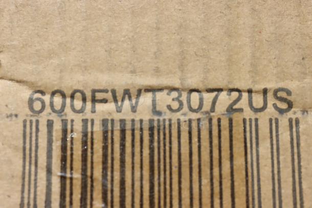 Barcode and model number "600FWT3072US" printed on a damaged cardboard box for a Regency stainless steel work table.