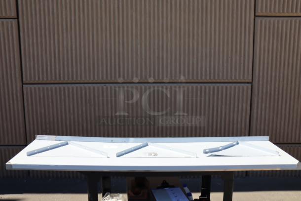 Brand new Regency 600WS1872HD 16-gauge stainless steel wall shelf, 18"x72". Slight scratches and dents visible.