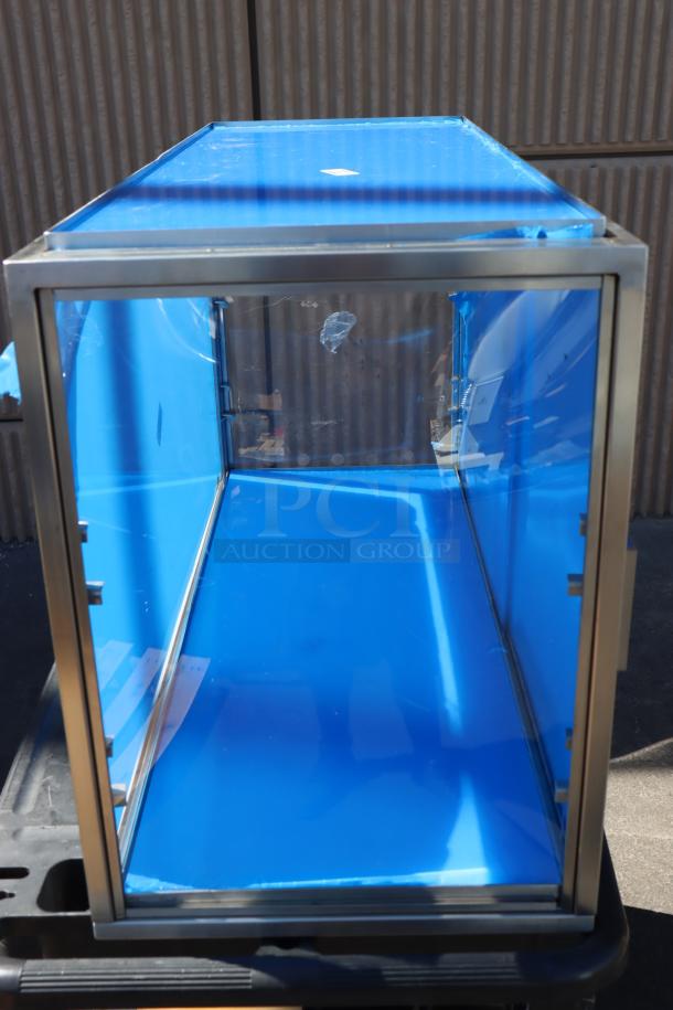 Cal-Mil 22323-55 3-Tier Bakery Display Case with stainless steel frame, blue protective film shown. Missing base panel.