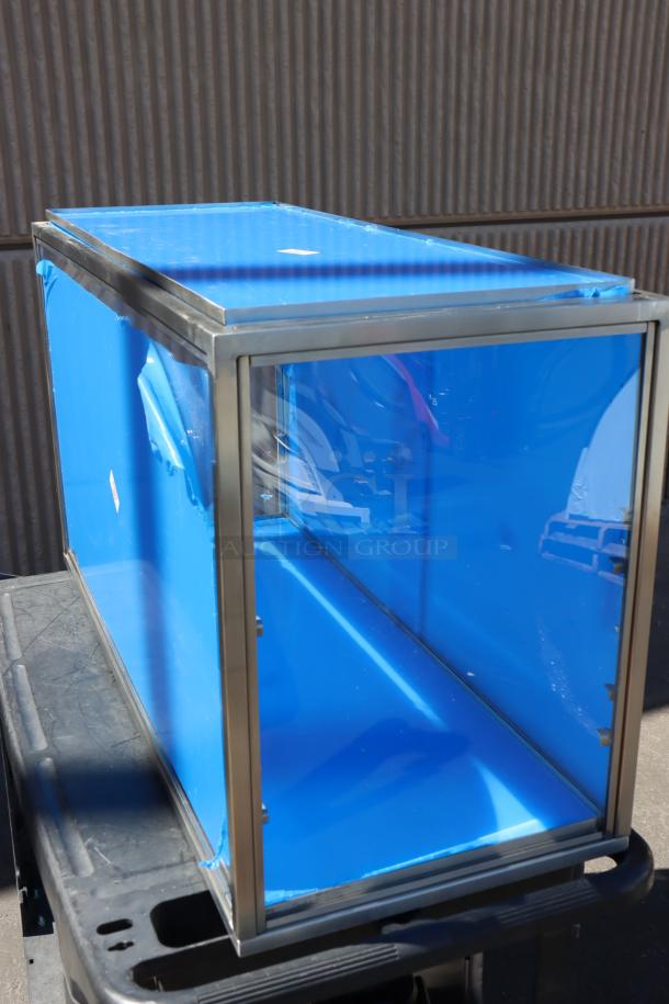 Brand new Cal-Mil 22323-55 bakery display case, 3-tier, 42"x17"x23", stainless steel frame, blue protective film, missing base panel.