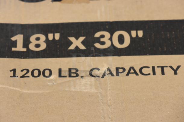 "18" x 30" 1200 LB. CAPACITY" printed on cardboard, indicating the size and weight capacity of a Lavex utility cart.