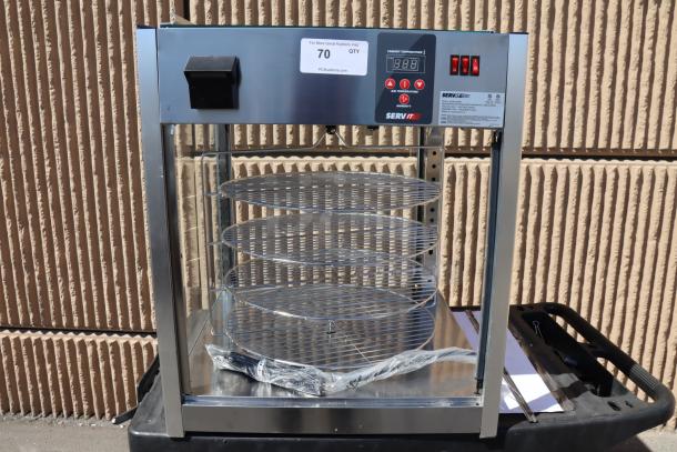 Brand new ServIt PDW18D1S 18" display warmer, dented, missing glass panels. Door on top. 4 shelves, 120V, 1,500W. Serial #1685004080132.