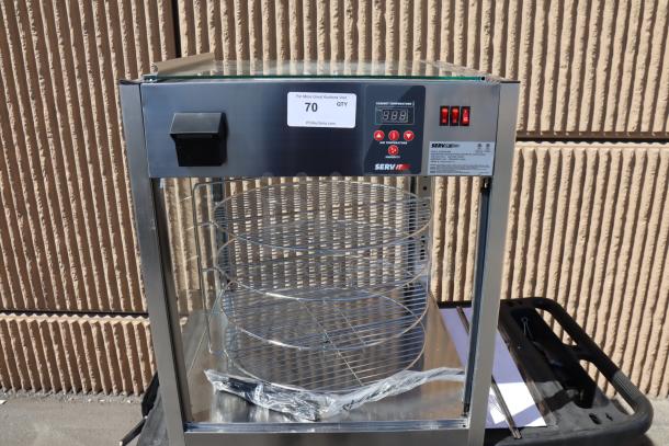 Brand new ServIt PDW18D1S display warmer, 18", 4 shelves. Dented, door on top, missing back and side glass. Serial #1685004080132.