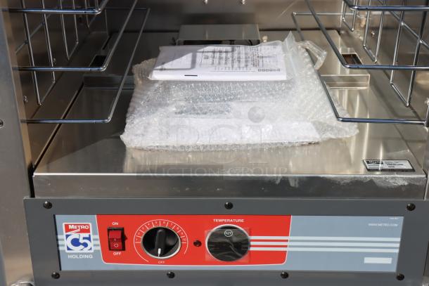 Brand new Metro C539-HLFS-4 hot holding cabinet with red panel, fixed wire slides. Power cord needs replacement.