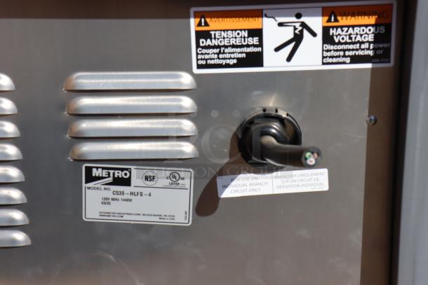 Metro C539-HLFS-4 hot holding cabinet, Model C539-HLFS-4 label, 120V, 1440W, warning signs, broken power cord visible.