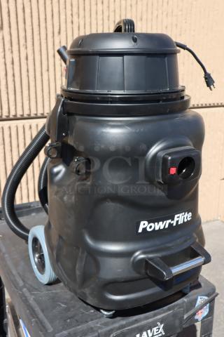 Powr-Flite PF56 20-gallon wet/dry vacuum, new, with toolkit. Black polyethylene body, 120V, 1,200W. Front wheels need service.