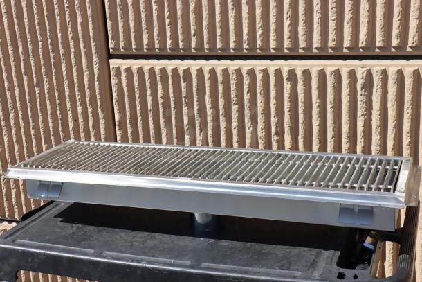 BRAND NEW Regency 600FT1242SS 12"x42" stainless steel floor trough with grate, 2 bent fins on one side.
