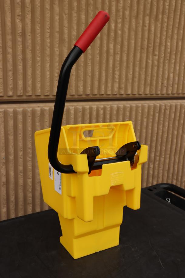 Brand new Rubbermaid® 2064959 WaveBrake® yellow down press mop wringer, features red handle and visible label.