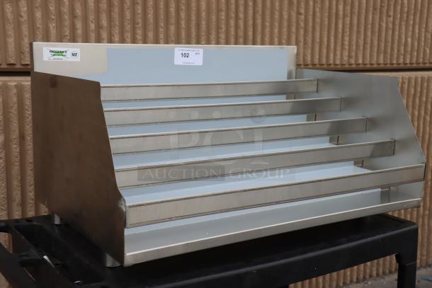 Brand new Regency 600LDR2336 five-tier stainless steel liquor display rack, 36" wide, 23" deep, minor scratches.