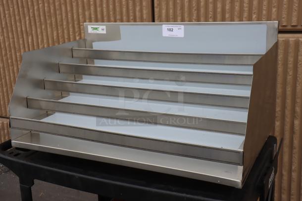 Brand new Regency 600LDR2336 five-tier stainless steel liquor display rack, 36" wide, 23" deep, visible minor scratches.
