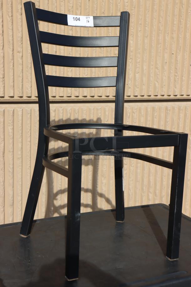 Lancaster Table & Seating black ladder back chair frame, model 164CMTLADFR, scratch-n-dent, tan wall backdrop.