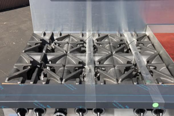 Garland G60-6G24RR range with 6 burners, 24" griddle, and 2 ovens, 310,000 BTU, new scratch-n-dent condition.