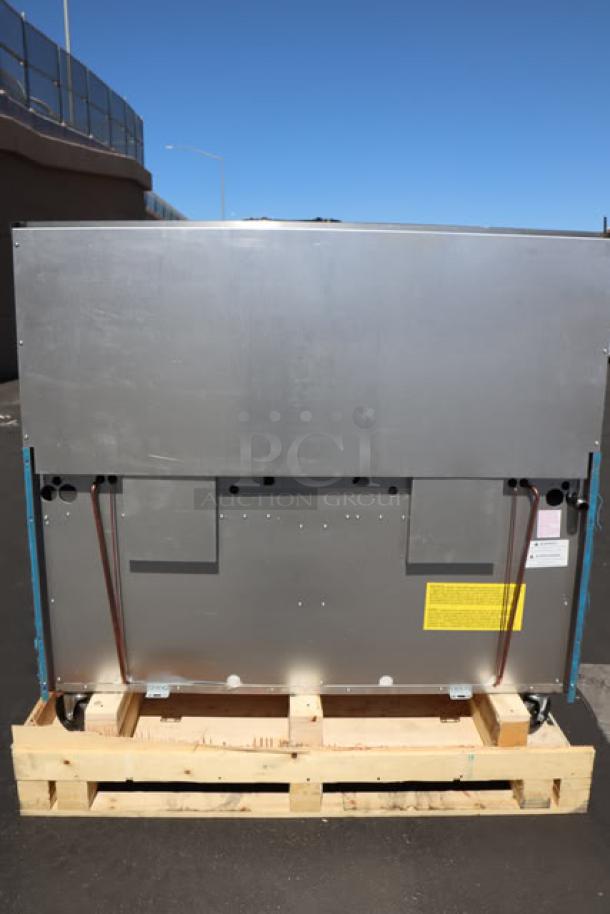 Brand new Garland G60-6G24RR natural gas range back view, 310,000 BTU, serial 2503100101708, mounted on a wooden pallet.