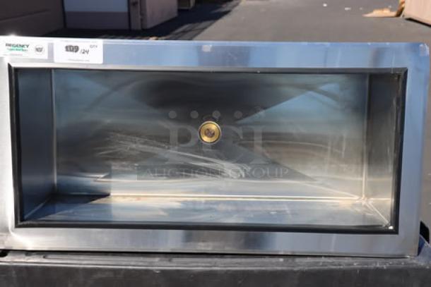 BRAND NEW Regency 600DIIB1836 stainless steel drop-in ice bin, 18" x 36". Corners are bent. Model and certification labels visible.