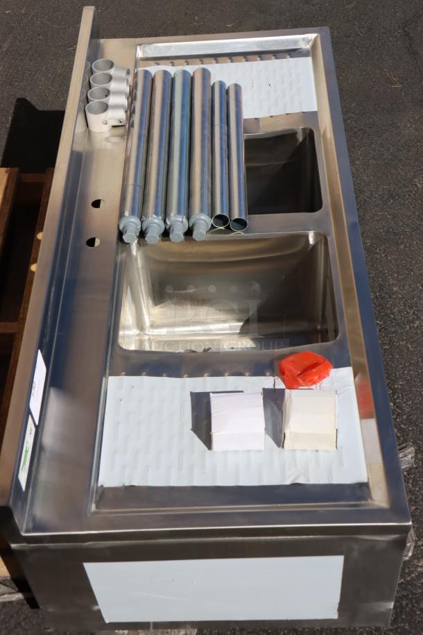 Brand new Regency 600B22148213 48" x 21" two-bowl underbar sink with dual 13" drainboards, unpackaged, may be missing parts.