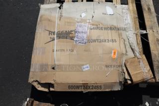 Regency 600WT24X24SS stainless steel work table in box, new scratch-and-dent, 24"x24", 16-gauge, labels visible.