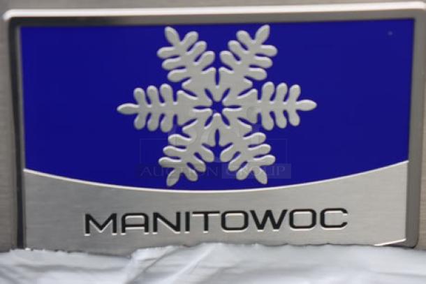 Badge showing Manitowoc logo with snowflake design on the IYT1200A-261 ice machine.