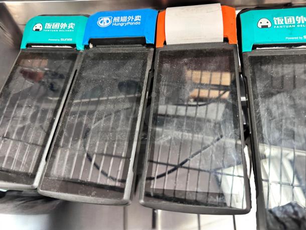 Lot of 4 Sunmi V2 POS handheld terminals with built-in printers, fully tested and operational. Labels feature delivery services.