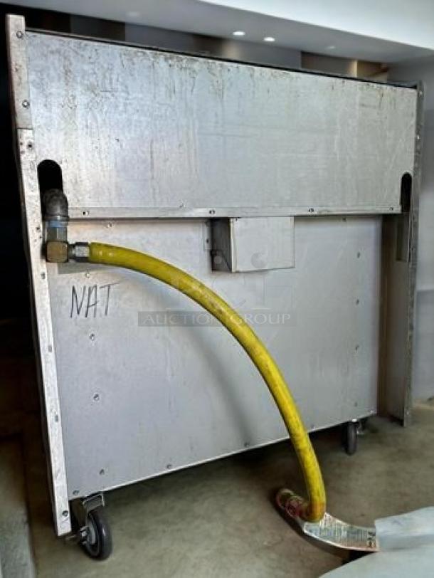 Outstanding condition Royal Range RSR-24, 4-burner natural gas range with oven base, fully tested and working, yellow gas hose attached.