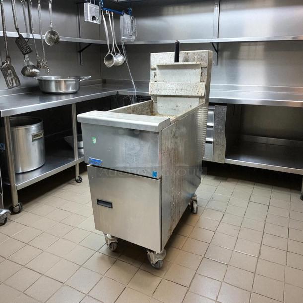 Pitco SG14-S stainless steel gas fryer, 40-50 lb. capacity, 110,000 BTU, fully tested, on castors in kitchen setting.