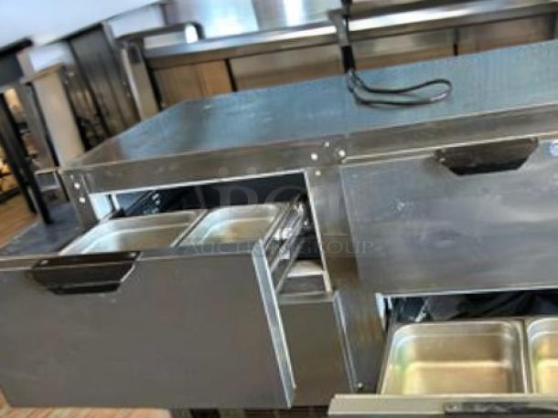 Turbo Air MST-72-N refrigerated prep table in outstanding condition, stainless steel, 115V, tested, featuring multiple compartments.