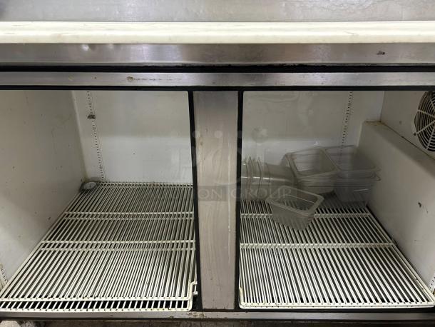 True TPP-AT-67-HC 67" refrigerated pizza prep table, 2 doors, tested and working, visible interior shelves, used condition.