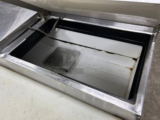 True TPP-AT-67-HC 67 3/8" refrigerated pizza prep table, excellent condition, stainless steel, open lid view.