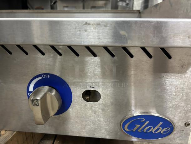Globe GG48G 48" gas griddle with manual controls, 1" steel plate. Excellent condition, tested and working, logo visible.