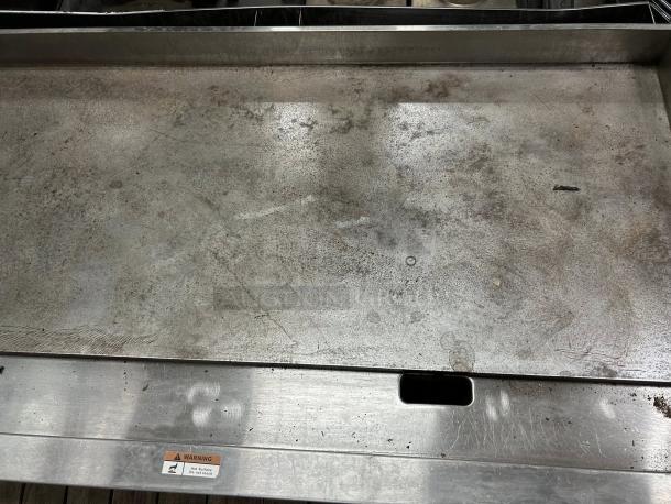 Globe GG48G 48" gas griddle, 1" steel plate, manual controls, excellent condition, warning label visible, tested working.
