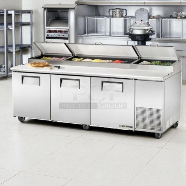 Excellent condition True TPP-93 pizza prep table, stainless steel, 93", three doors, accommodates (12) 1/3 pans, tested working.