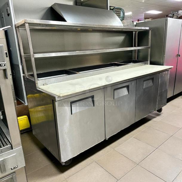 True TPP-93 93" 3-door refrigerated pizza prep table, excellent condition, holds twelve 1/3 pans, 115v, tested and working.