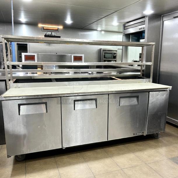 True TPP-93 93" refrigerated pizza prep table, 3-door, stainless steel, includes 12 1/3 pans, excellent condition.