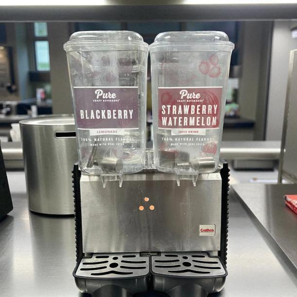 Crathco D25-4 refrigerated drink dispenser with two 5-gallon bowls, displaying "Blackberry" and "Strawberry Watermelon" labels.