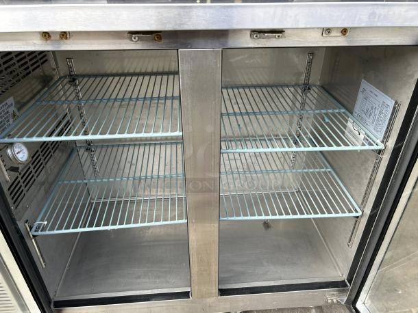Avantco UBB-48G-HC-S back bar refrigerator, stainless steel, glass doors, LED lighting, thermometer, visible interior wiring.