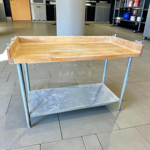John Boos DNS09 72" maple top baker's table with 4" splash and undershelf. Good condition, sturdy steel legs.