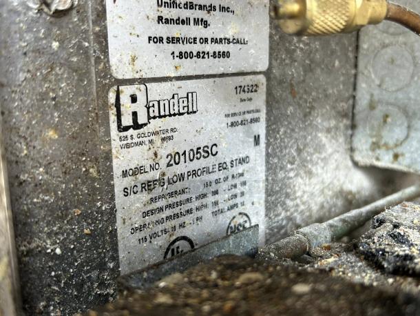 Randell 20105SC-32-6 chef base label, featuring model number, refrigerant details, and 115v power specs. Dusty condition visible.