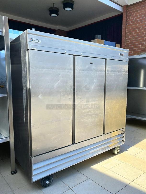 Kintera KBM3F three-section bottom mount freezer, stainless steel, tested and working, 81" wide, on wheels.