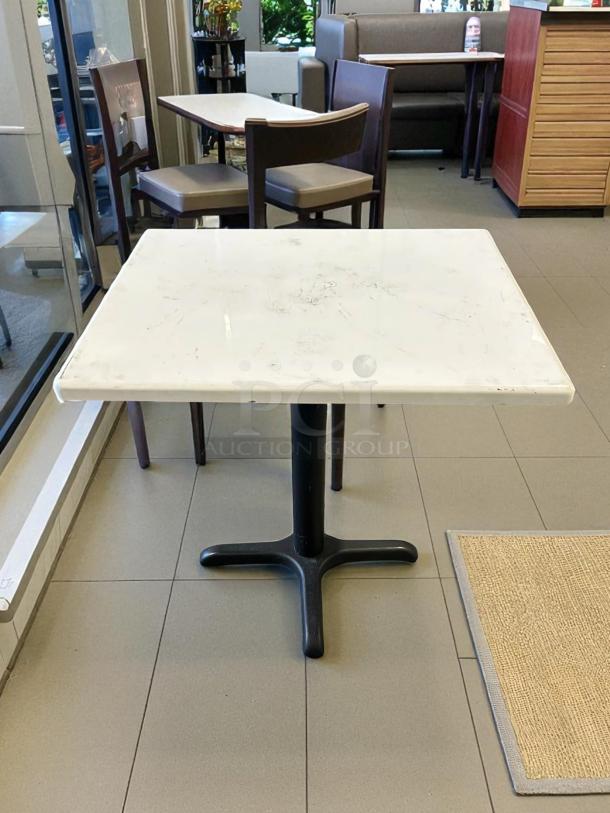 White dining table, 36"x30", great condition, sturdy black base, ideal for dining spaces.