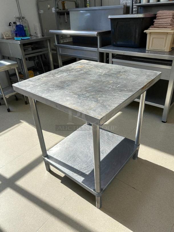 30"x30" stainless steel worktop table, great condition, sturdy design, lower shelf, ideal for kitchen or workshop use.