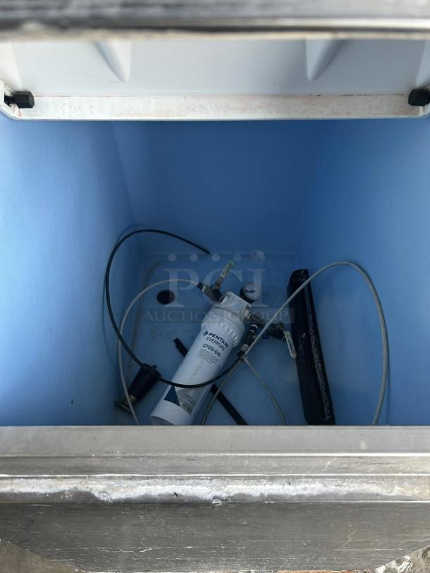 Hoshizaki KM-350MAJ ice machine interior with visible wiring and Pentair water filter inside compartment.