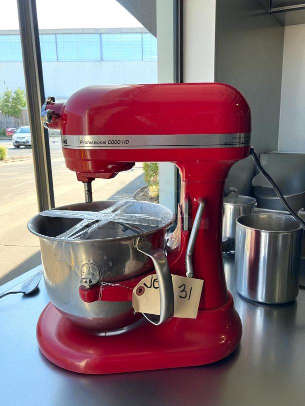 KitchenAid Professional 6000 HD stand mixer in red, 6-quart. Tested, working condition. Includes stainless steel bowl. Tag reads "31".